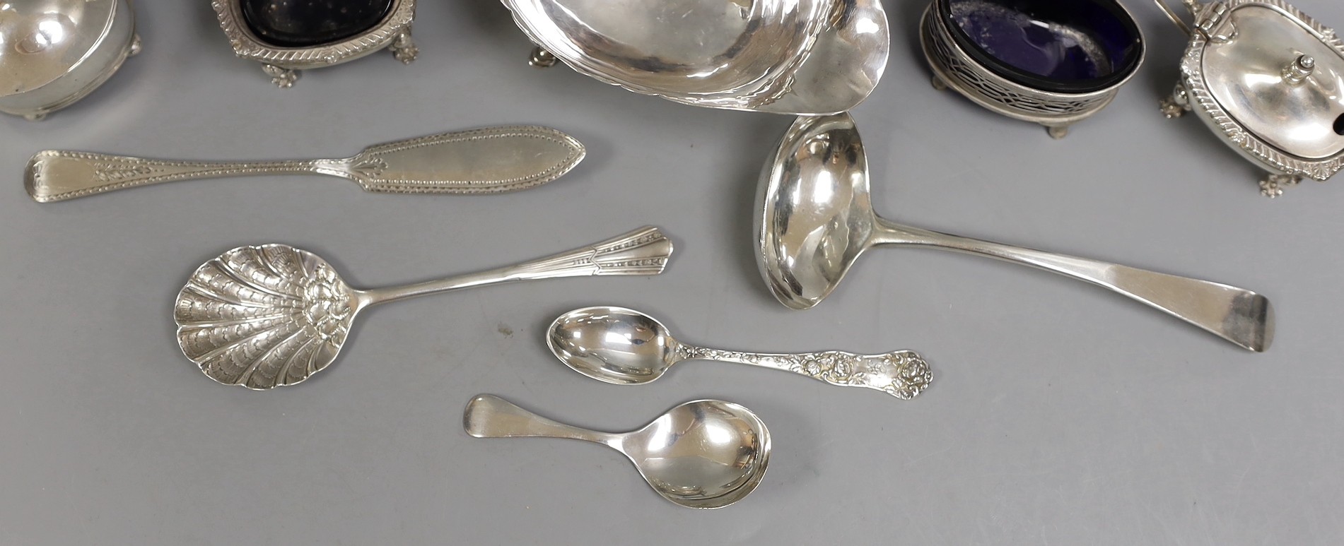 A George V silver sauce boat, Chester 1911, together with four silver condiments, a Georgian silver sauce ladle by William Bateman and four other items of silver cutlery.